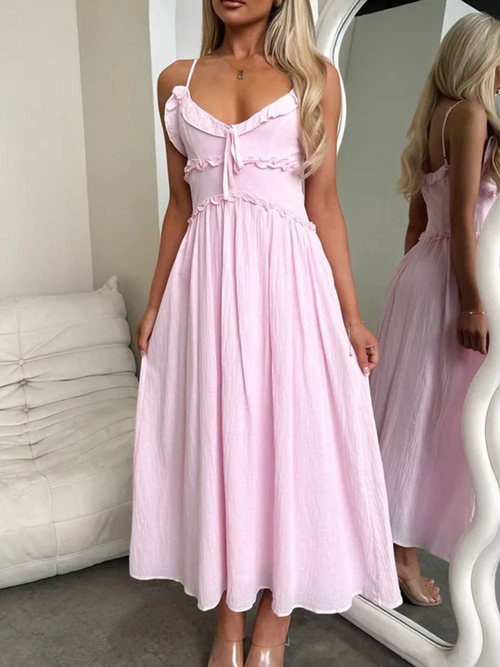 Pink ruffled midi dress with spaghetti straps and tie-front detail