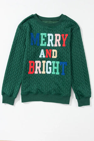 Textured dark green sweatshirt with "Merry and Bright" applique text in colorful letters.