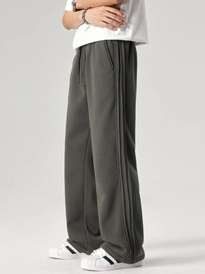 Men's dark gray relaxed fit sweatpants with drawstring and side seam detail.