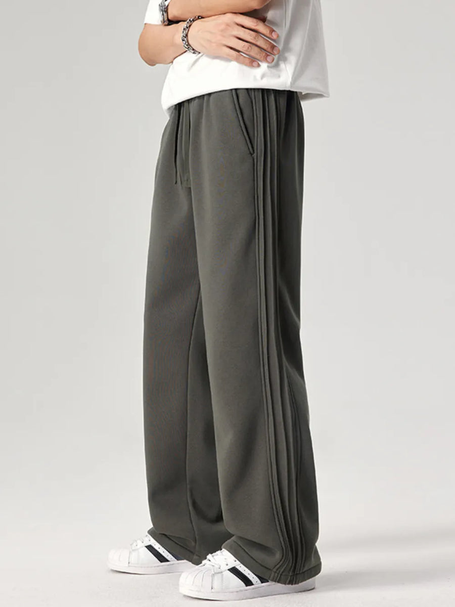 Men's dark gray relaxed fit sweatpants with drawstring and side seam detail.