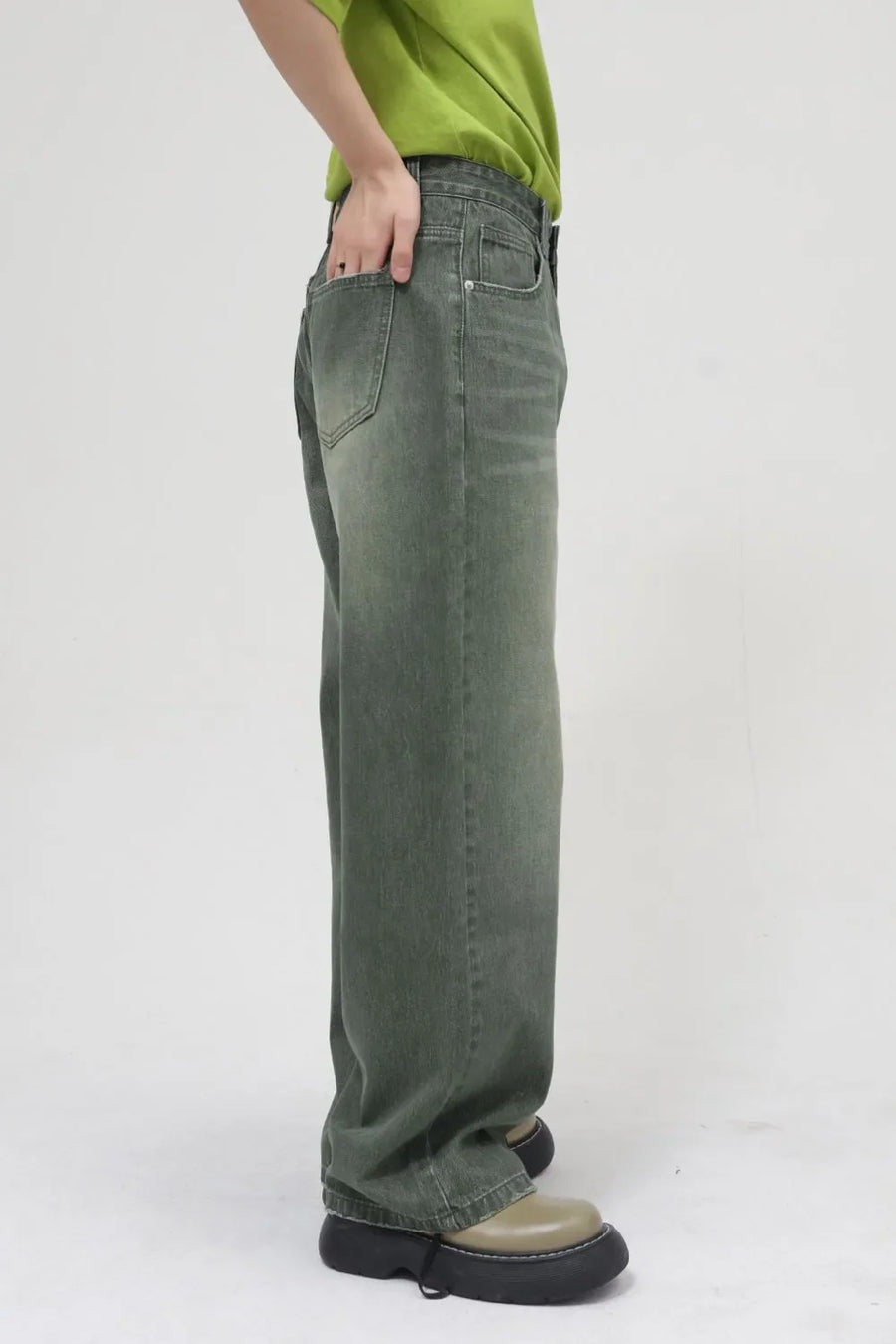 Faded olive relaxed wide leg denim jeans with a faded wash and casual styling.