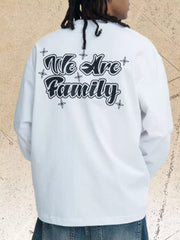 White long sleeve tee with black "We Are Family" graphic print and star accents