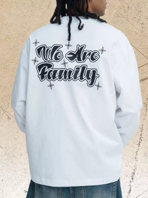 White long sleeve tee with black "We Are Family" graphic print and star accents