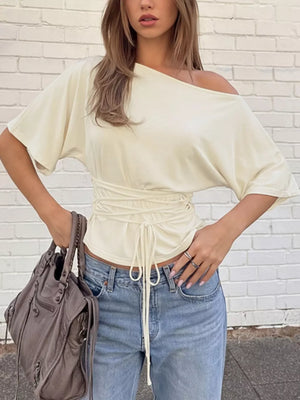 Apricot draped tie-front short sleeve t-shirt with dolman sleeves and asymmetrical neckline.