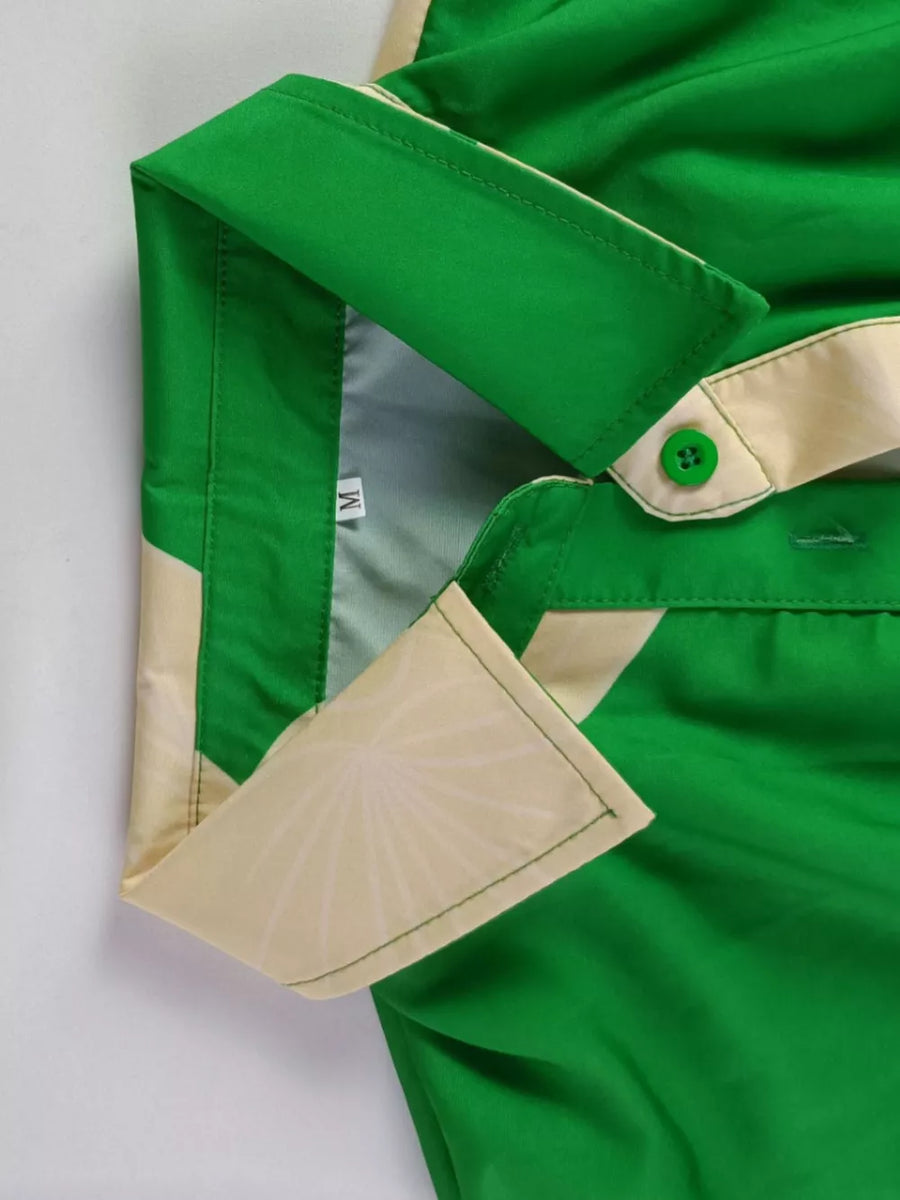 Green abstract print belted shirt dress with collared neckline and button details.