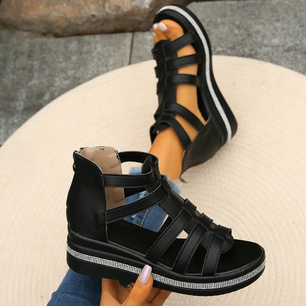 Black gladiator wedge sandals with crystal trim and side zipper.