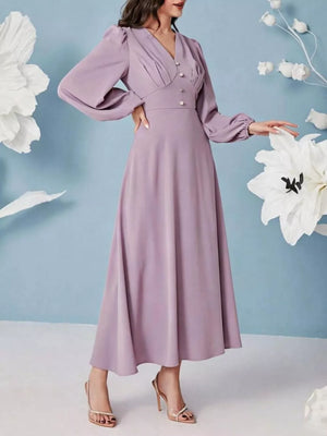 Elegant ruched maxi dress in lavender with balloon sleeves and decorative buttons.