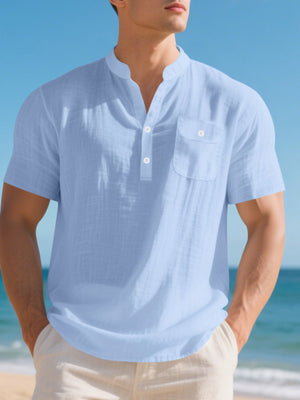 Light blue cotton band collar short sleeve shirt with chest pocket and button placket.