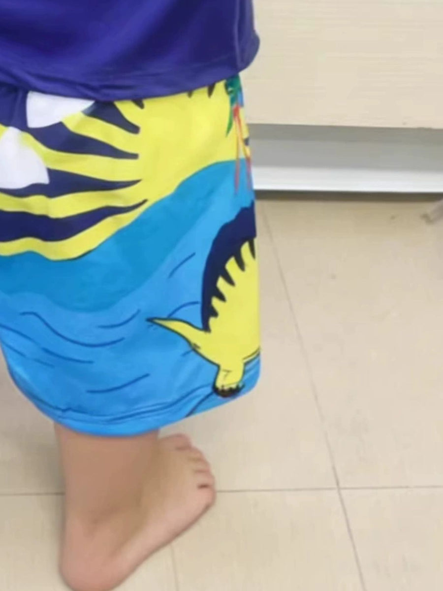 Toddler blue shorts with yellow dinosaur and palm tree print