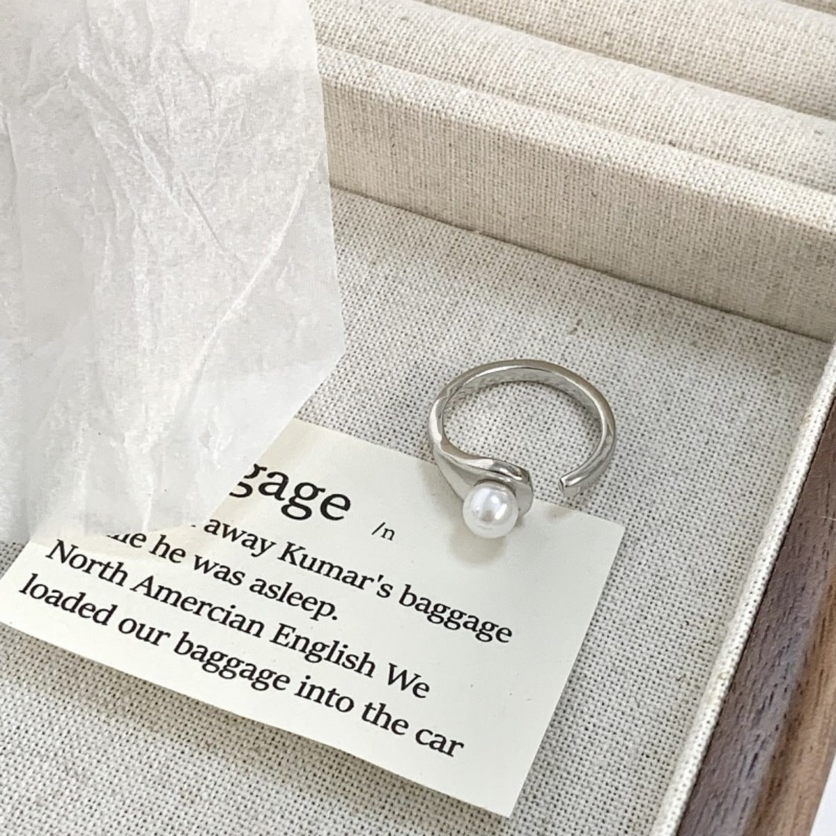ring in silver featuring pearl accent and open cuff fit