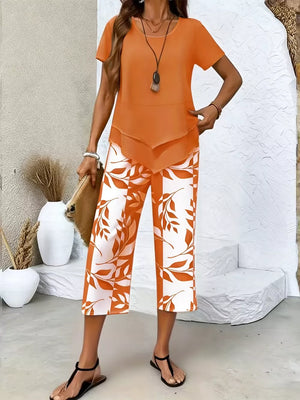 Orange layered short sleeve top with leaf print capri pants.