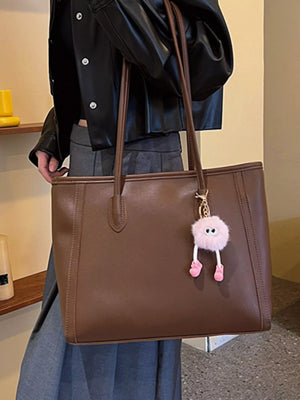Brown PU leather tote bag with a fluffy pink charm and double straps.
