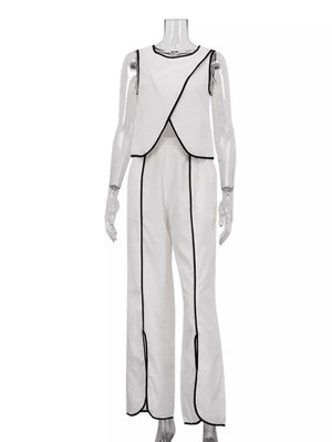 White sleeveless top and wide leg pants set with black trim and side slits