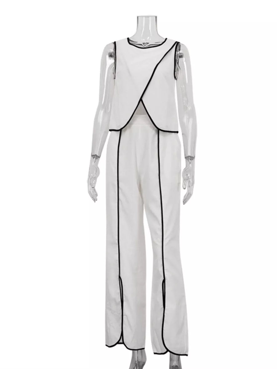 White sleeveless top and wide leg pants set with black trim and side slits