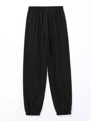 Black sweatpants with elastic waistband and cuffs, featuring subtle butterfly embellishments.