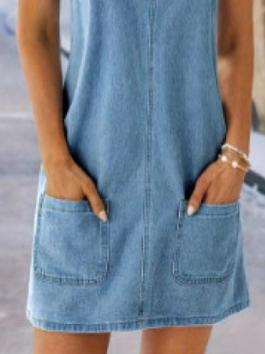 Denim overall dress with wide straps, A-line cut, and front pockets.