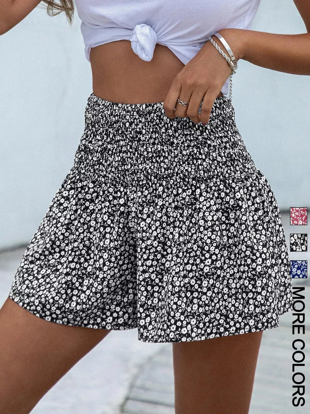 Black floral chino shorts with elastic smocked waist and a-line cut.