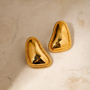 Sculpted gold vermeil earrings with textured edges and a polished finish.