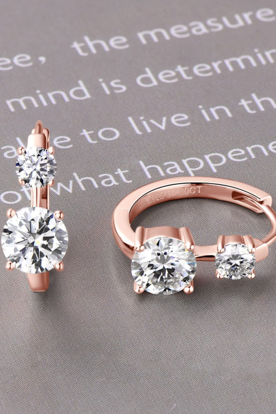 Rose gold double stone huggie hoop earrings with clear cubic zirconia stones.
