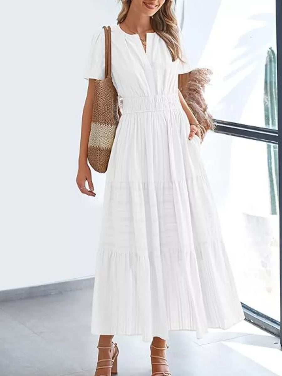 White ruched V-neck tiered midi dress with short sleeves and pockets.