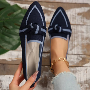 Dark blue knit bow loafers with contrast trim and pointed toe.