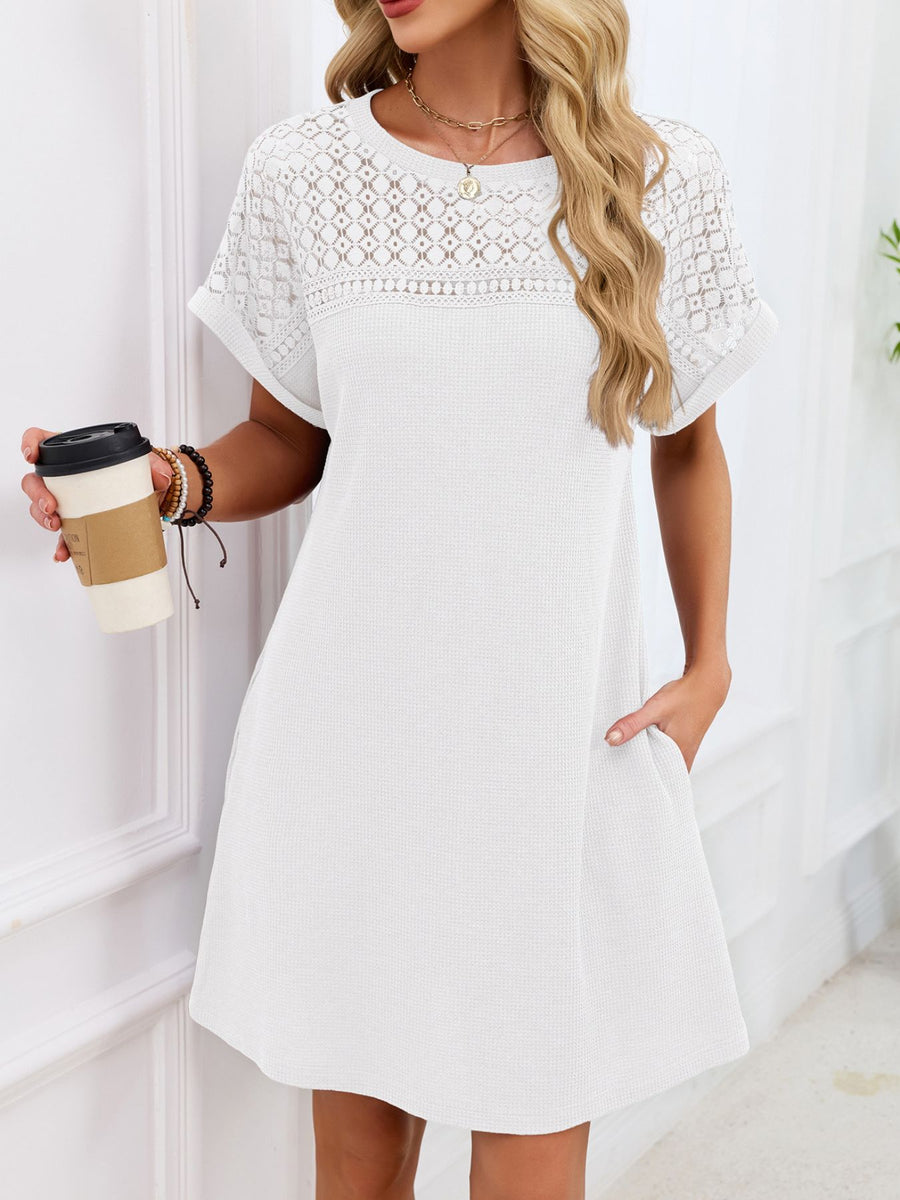 White t-shirt dress with sheer lace yoke and short sleeves, above knee length