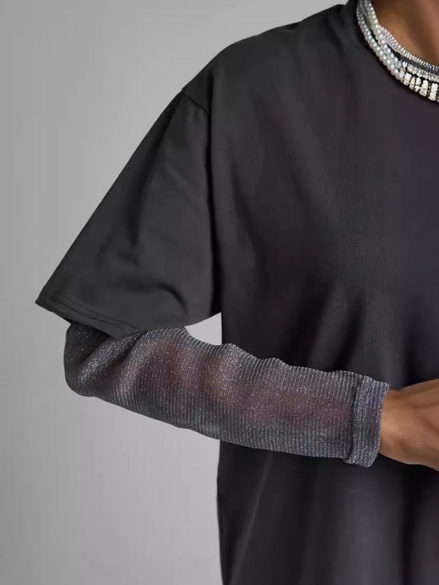 Oversized black t-shirt with sheer, ribbed, metallic sleeves.
