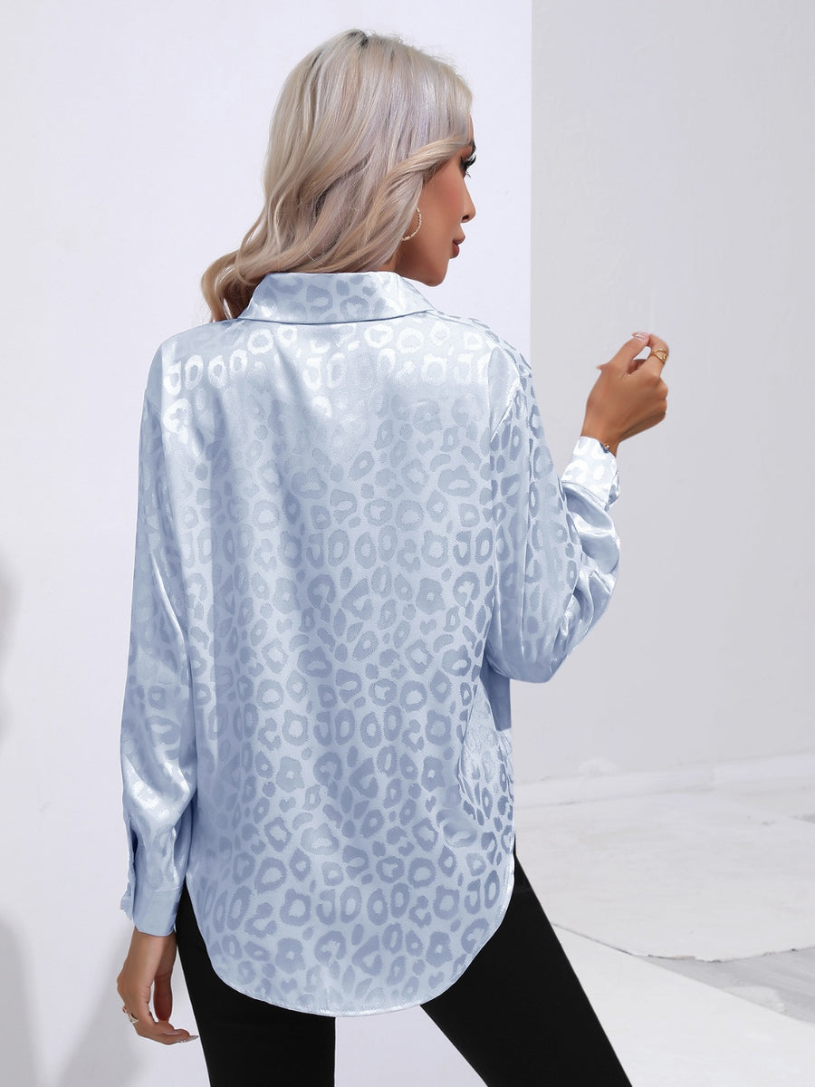 Light blue satin leopard print button-down shirt with a collared neckline and long sleeves.