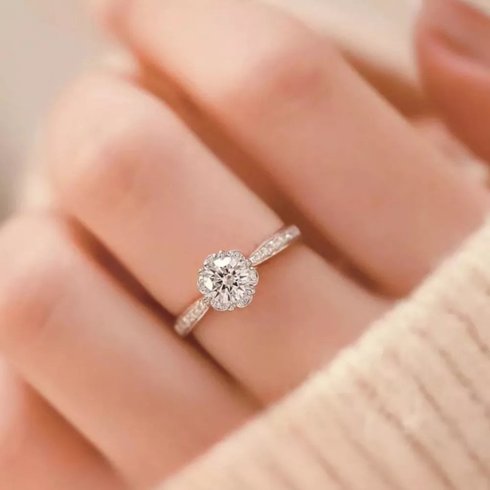 ring in silver featuring halo setting and straight fit