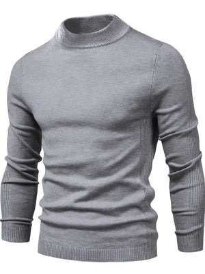 Gray ribbed mock neck sweater with sculpted shoulder detail and long sleeves.