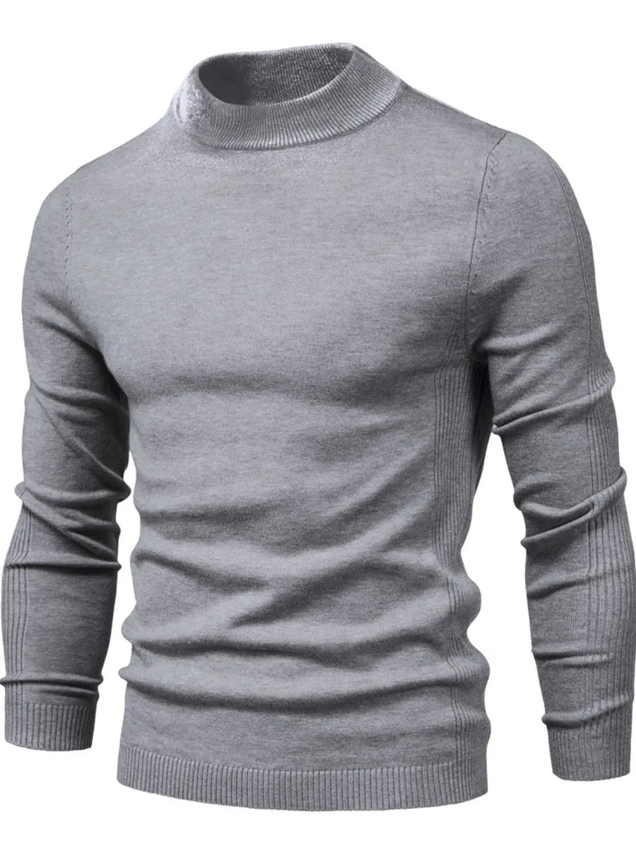 Gray ribbed mock neck sweater with sculpted shoulder detail and long sleeves.