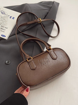 Brown oval pu leather crossbody bag with embossed logo and adjustable strap