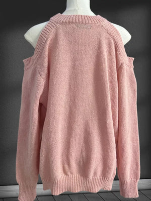 Pink cold shoulder knit sweater with crew neck and ribbed cuffs and hem.