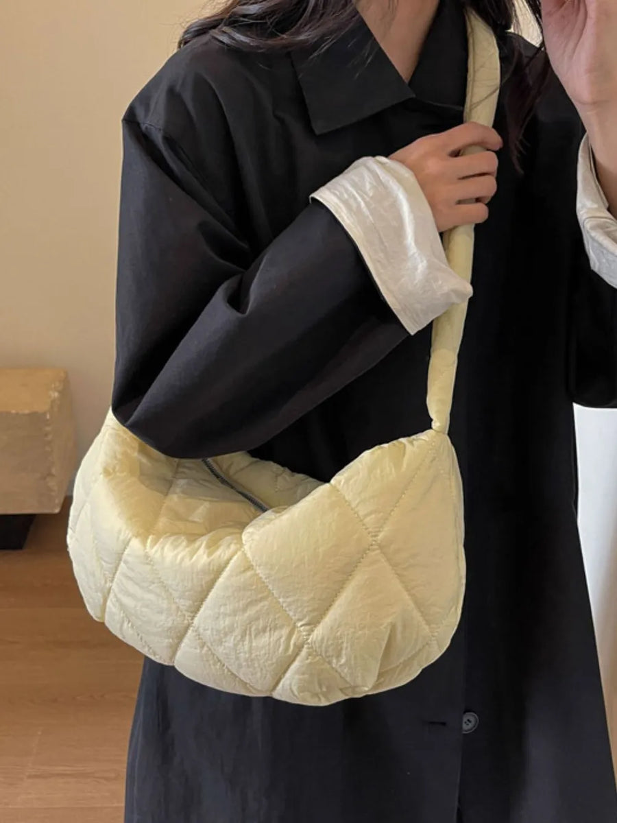 Quilted crossbody bag in pastel yellow with a diamond pattern.