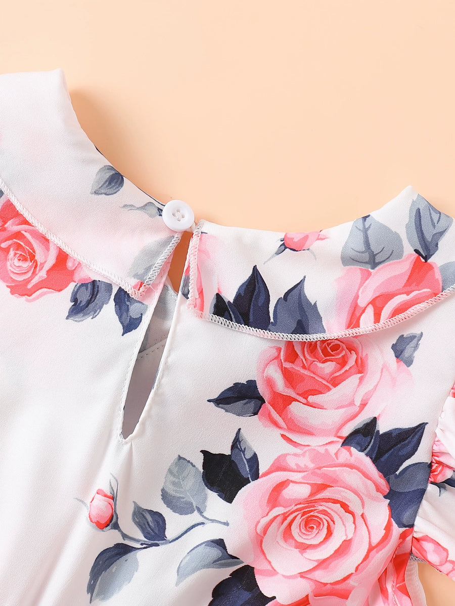 Toddler dress with floral print, Peter Pan collar, and ruffle trim.