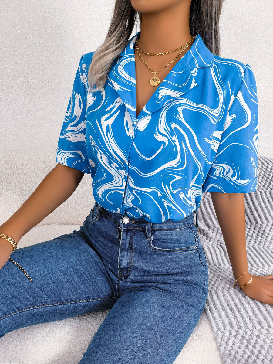 Sky blue swirl print camp collar blouse with short sleeves.