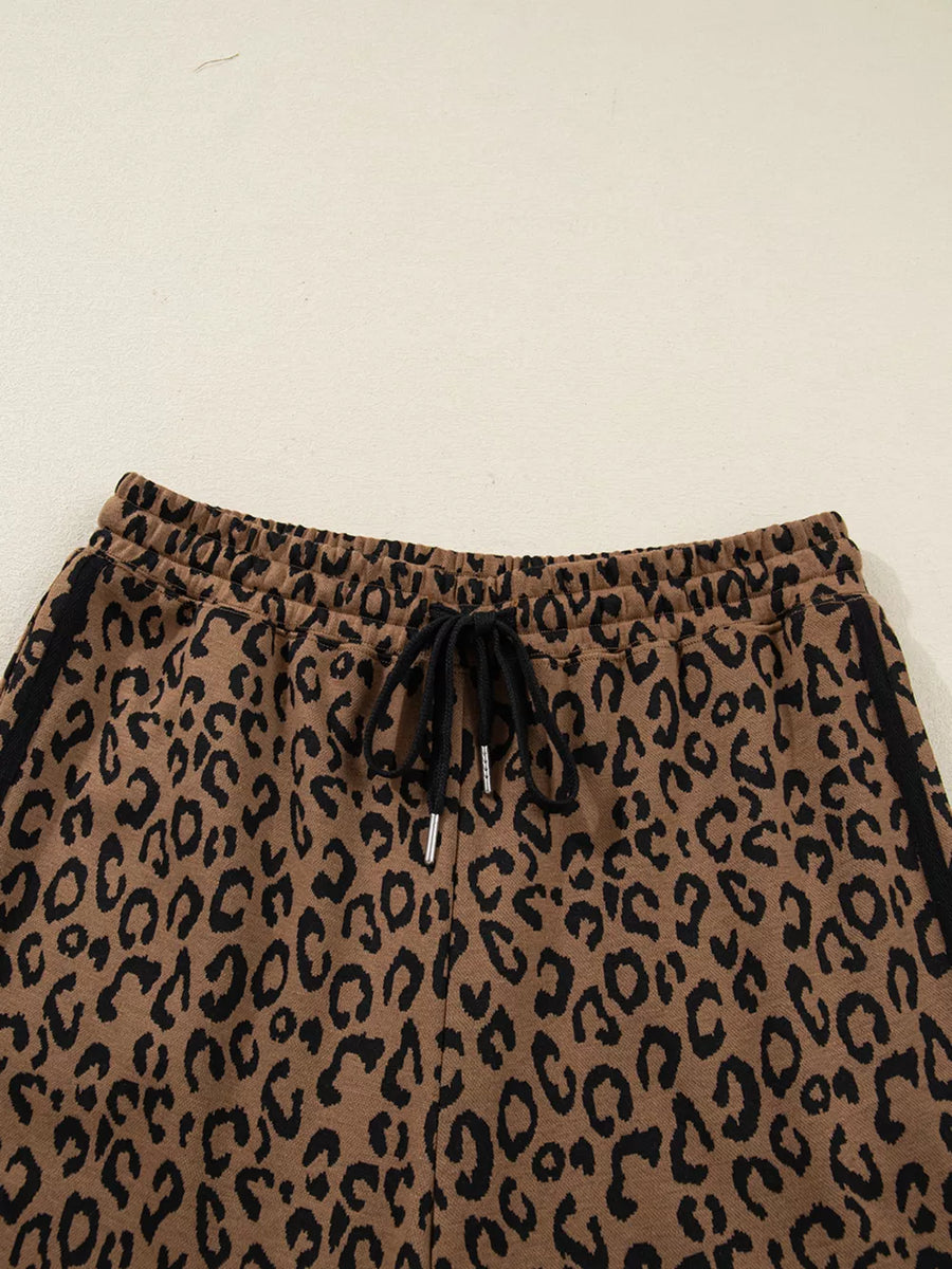 Brown leopard print joggers with drawstring waist and black side stripes.