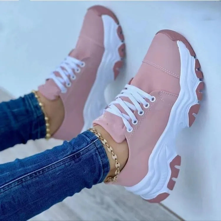 Pink chunky sole lace-up sneakers with white laces and soles.