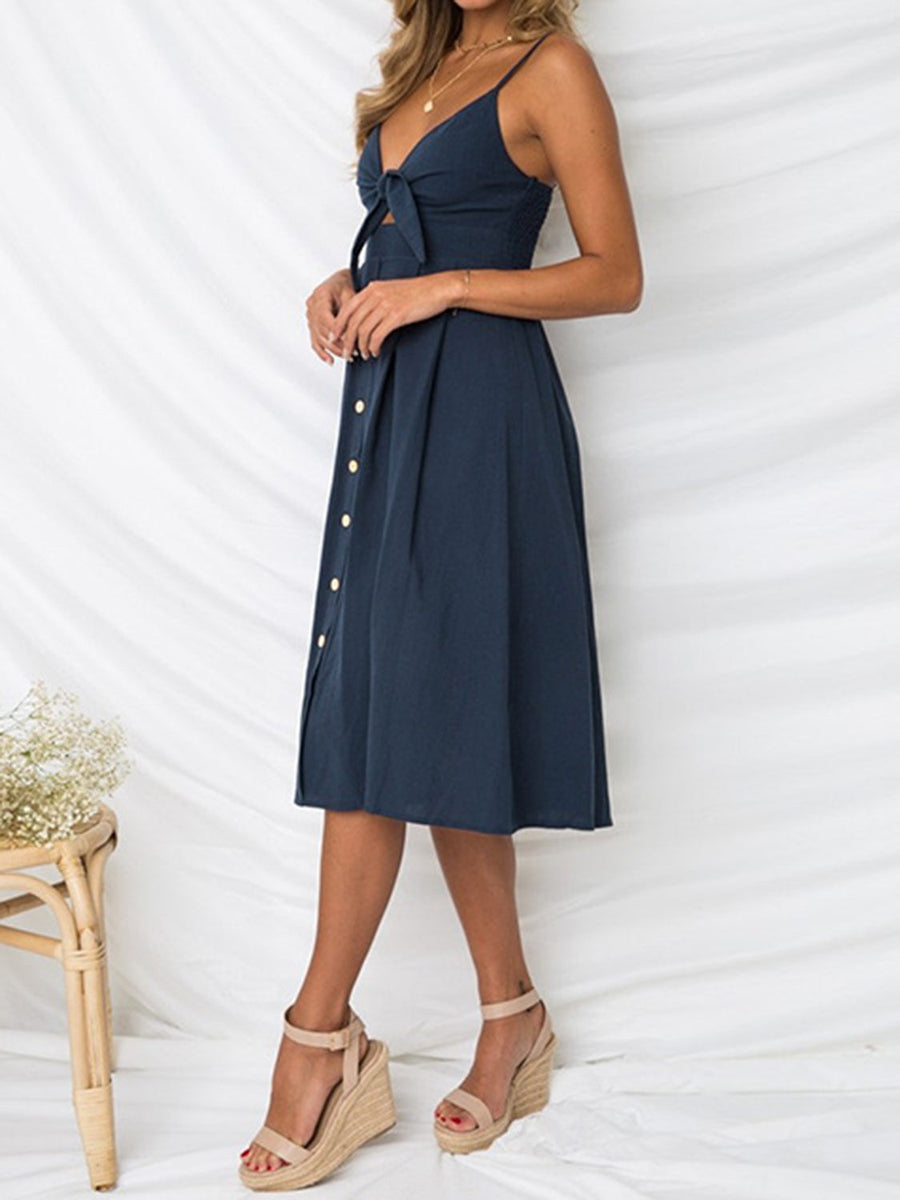 Dark blue midi sundress with bow-front, button detail, and cami straps.