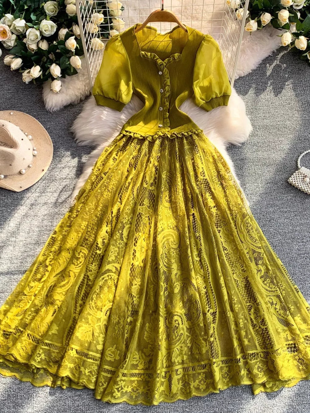 Lace-embellished puff sleeve dress in olive green with button front and ruffled neckline.