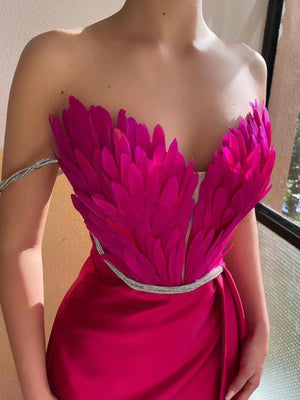 Rose Red feather embellished maxi dress with a strapless neckline and crystal belt.