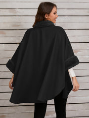 Black cape coat with faux fur trim on collar and cuffs.