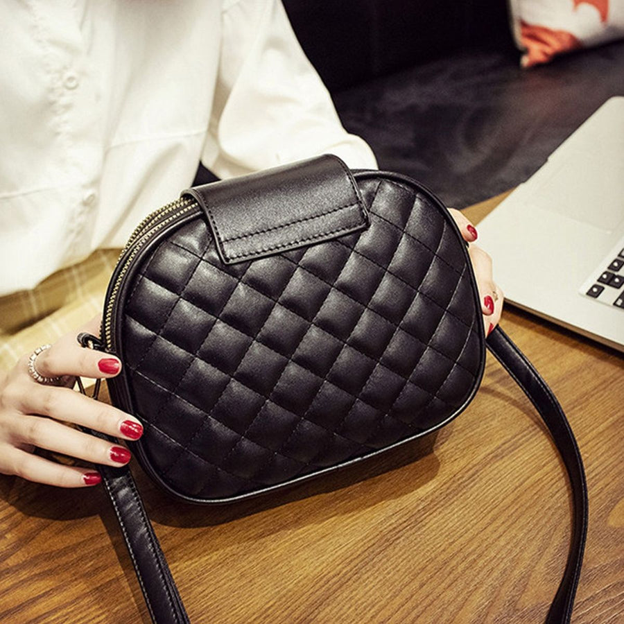 black crossbody bag with turn-lock, zip and quilted
