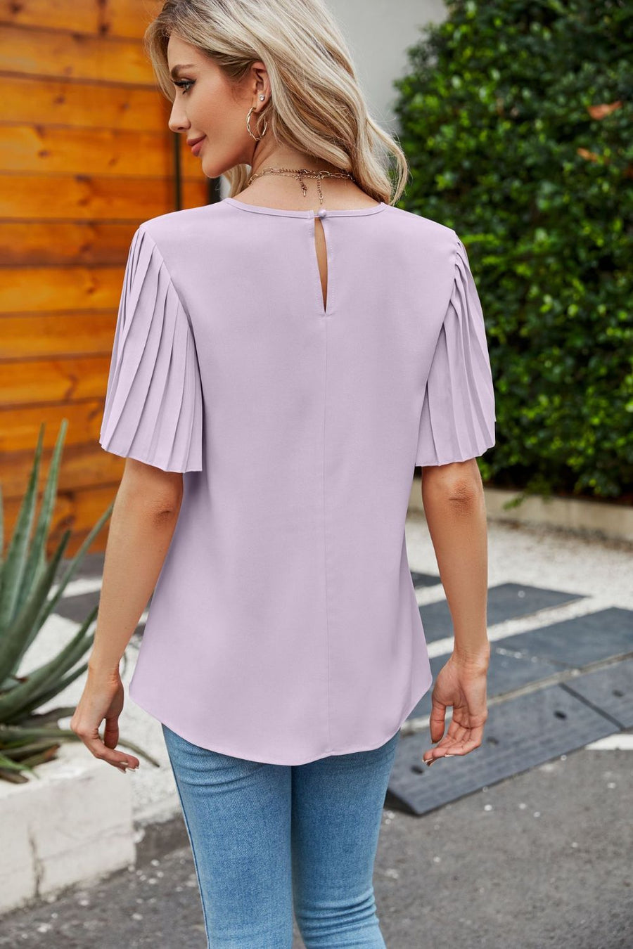 Lilac blouse with pleated short sleeves and keyhole back detail.