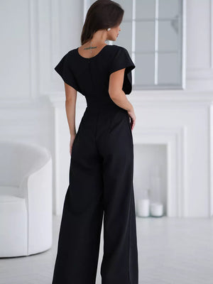 Black wide-leg romper with flutter sleeves and surplice neckline, shown from the back.