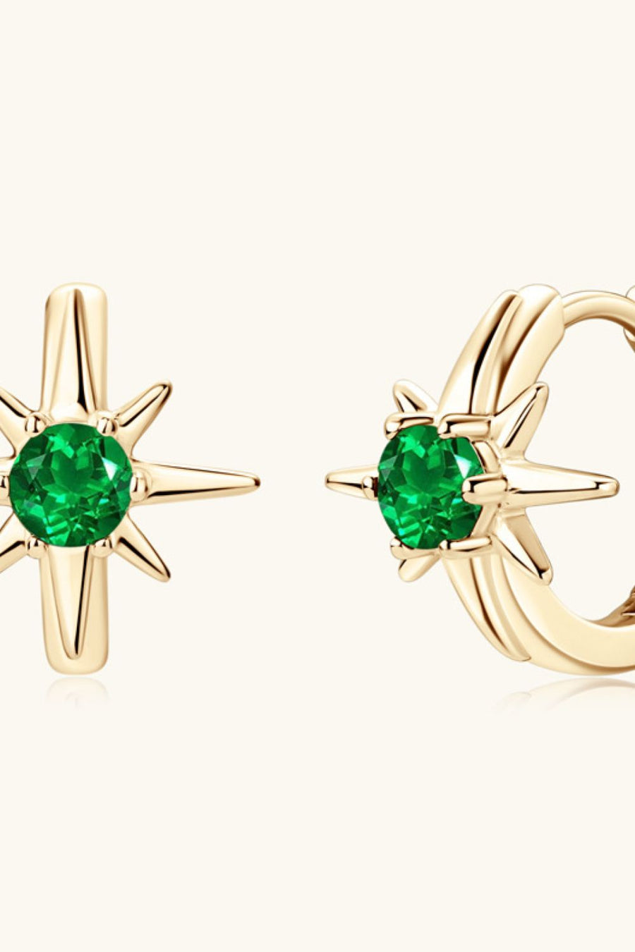 Gold starburst hoop earrings with emerald green center stones