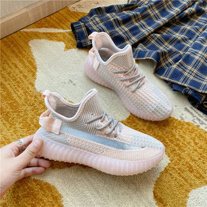 Textured knit platform sneakers in light pink and gray with translucent pink soles.
