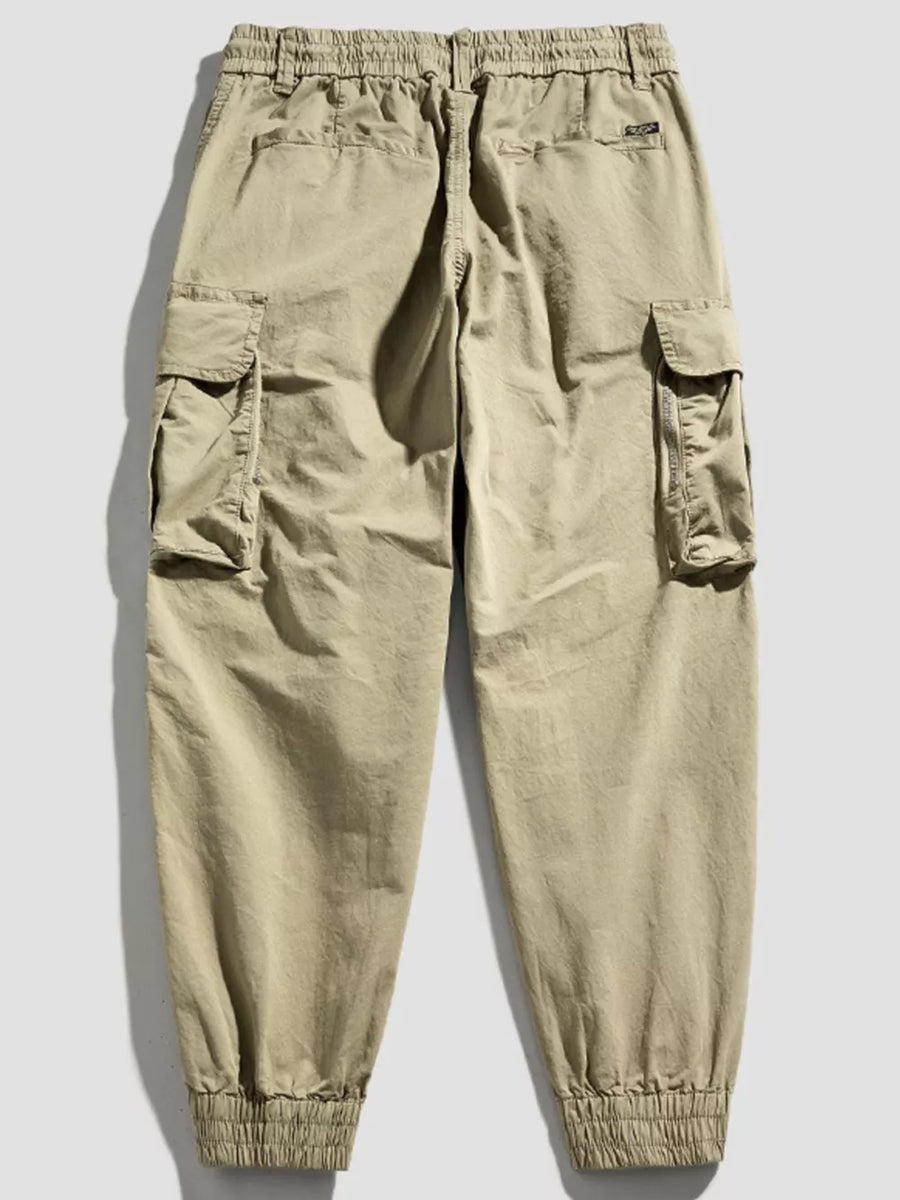 Khaki cargo joggers with flap pockets and elastic cuffs.