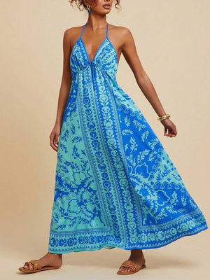 Floral halter maxi dress with plunging neckline and flowing skirt in blue and teal.
