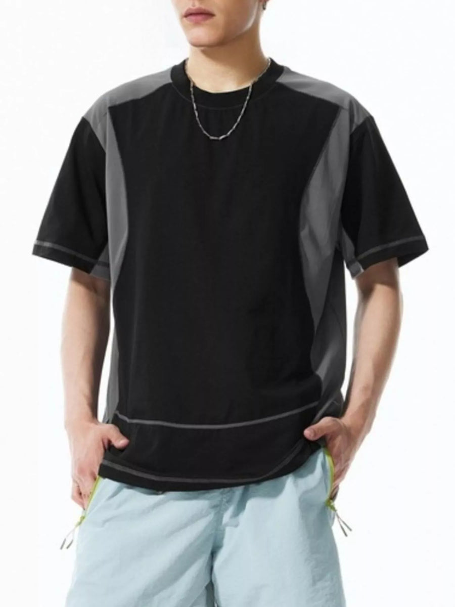 Men's black t-shirt with grey contrast panels and stitching, relaxed fit, short sleeves.